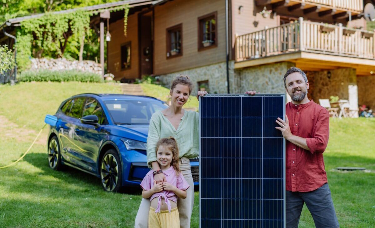Happy,Family,Posing,With,Photovoltaics,Panel,During,Their,Electric,Car