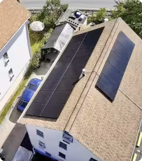 Aerial view of a Massachusetts home with solar panels installed on the roof, showcasing renewable energy solutions and energy savings potential.