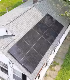Solar panels installed on a residential roof, showcasing clean energy solutions and potential for reducing electric bills in Massachusetts.