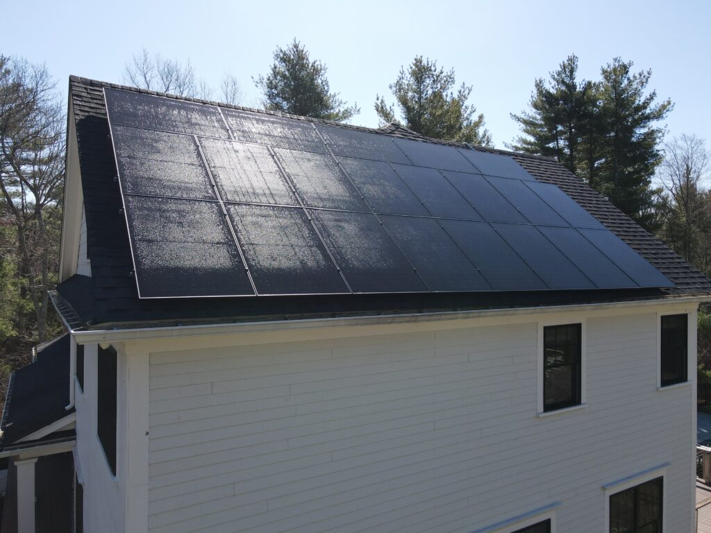 Modern white home with full roof solar panel coverage by Sunfinity Power