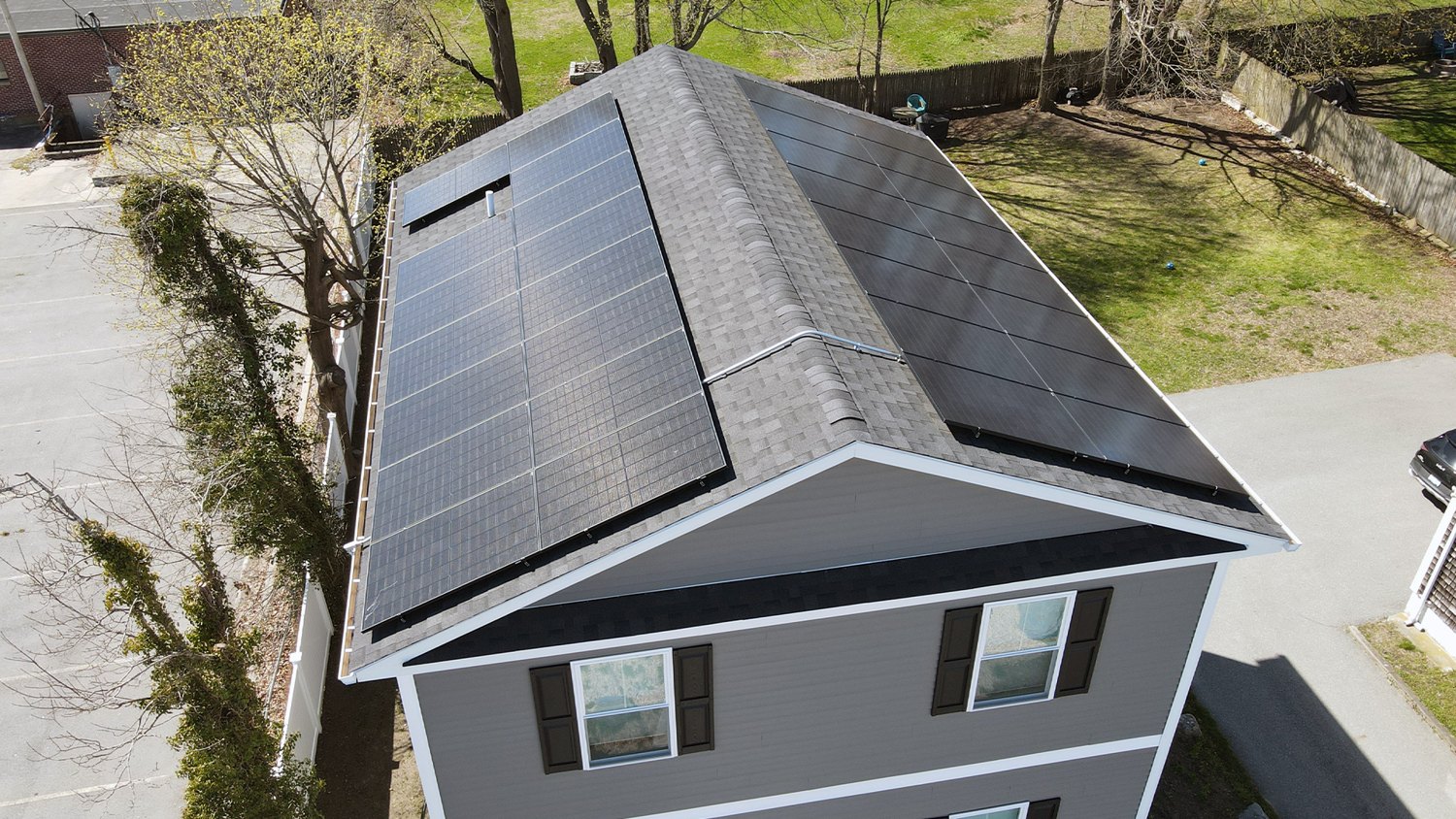 The same New England home after Sunfinity Power installed an all-black solar array on the new roof